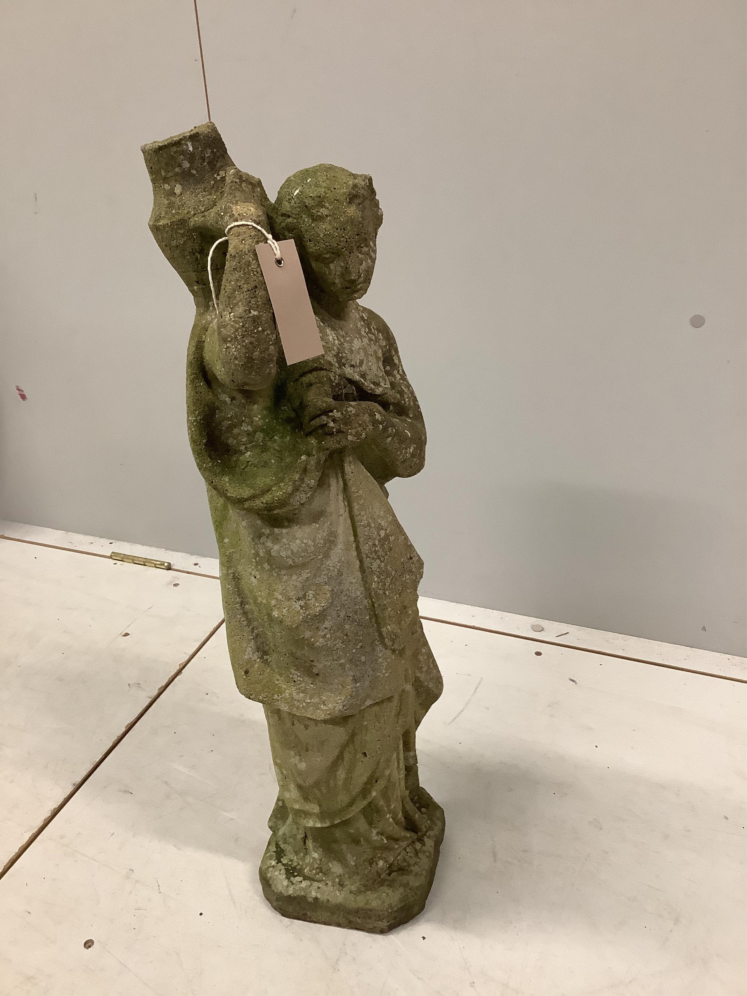 A reconstituted stone garden figure of a female water carrier, height 73cm. Condition - heavily weathered.